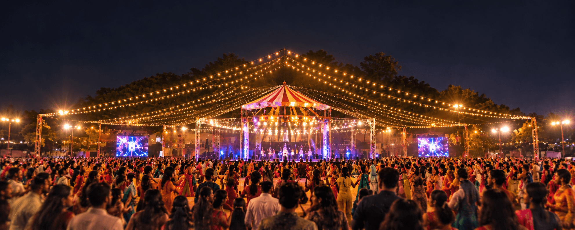 Large Garba celebration with a crowd gathered around the stage